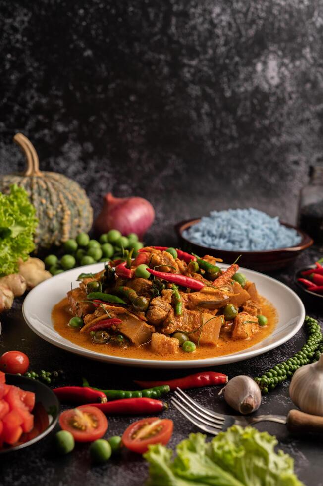 Red curry with pork in a white plate photo