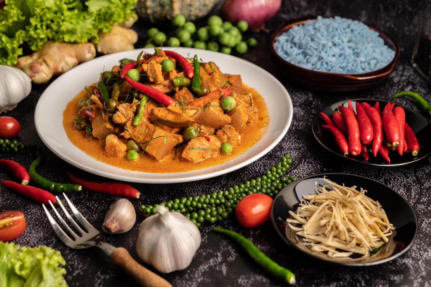 Red curry with pork in a white plate photo
