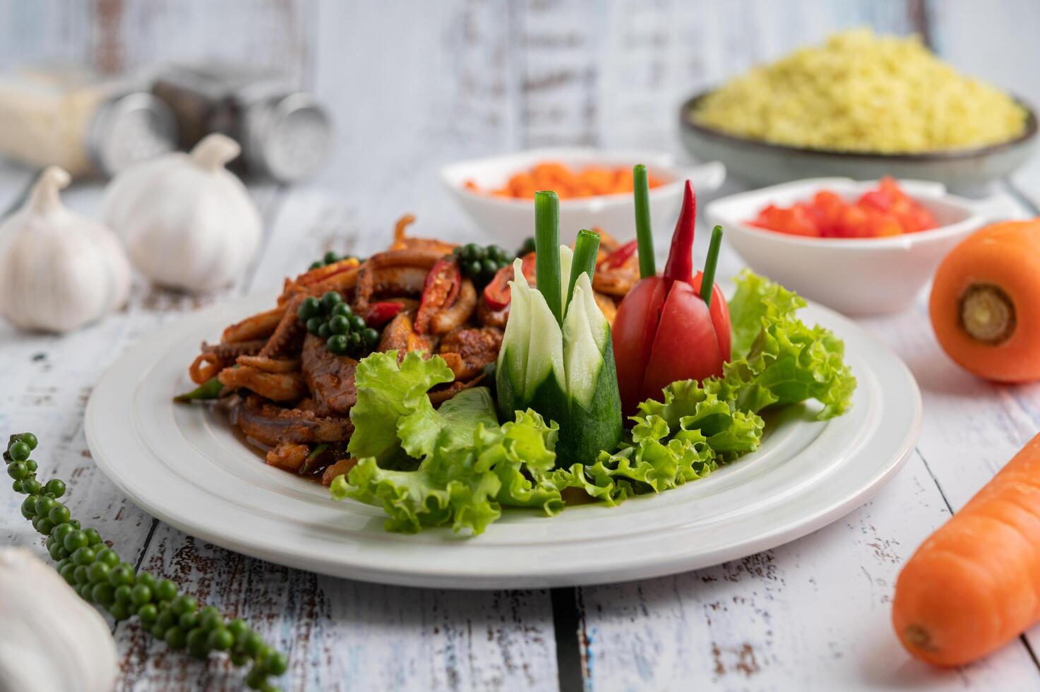 Stir-fried squid with curry paste in white plate. photo