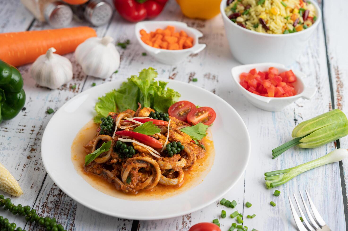 Stir-fried squid with curry paste in white plate. photo