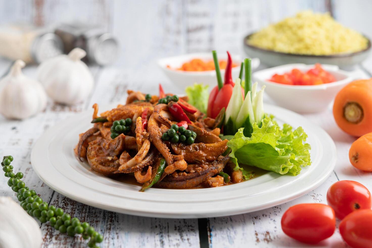 Stir-fried squid with curry paste in white plate. photo