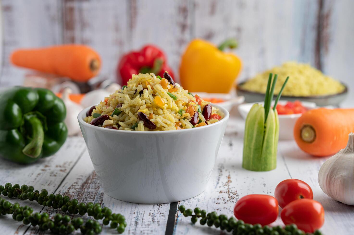 Mixed fried rice in a cup on a white wooden floor photo