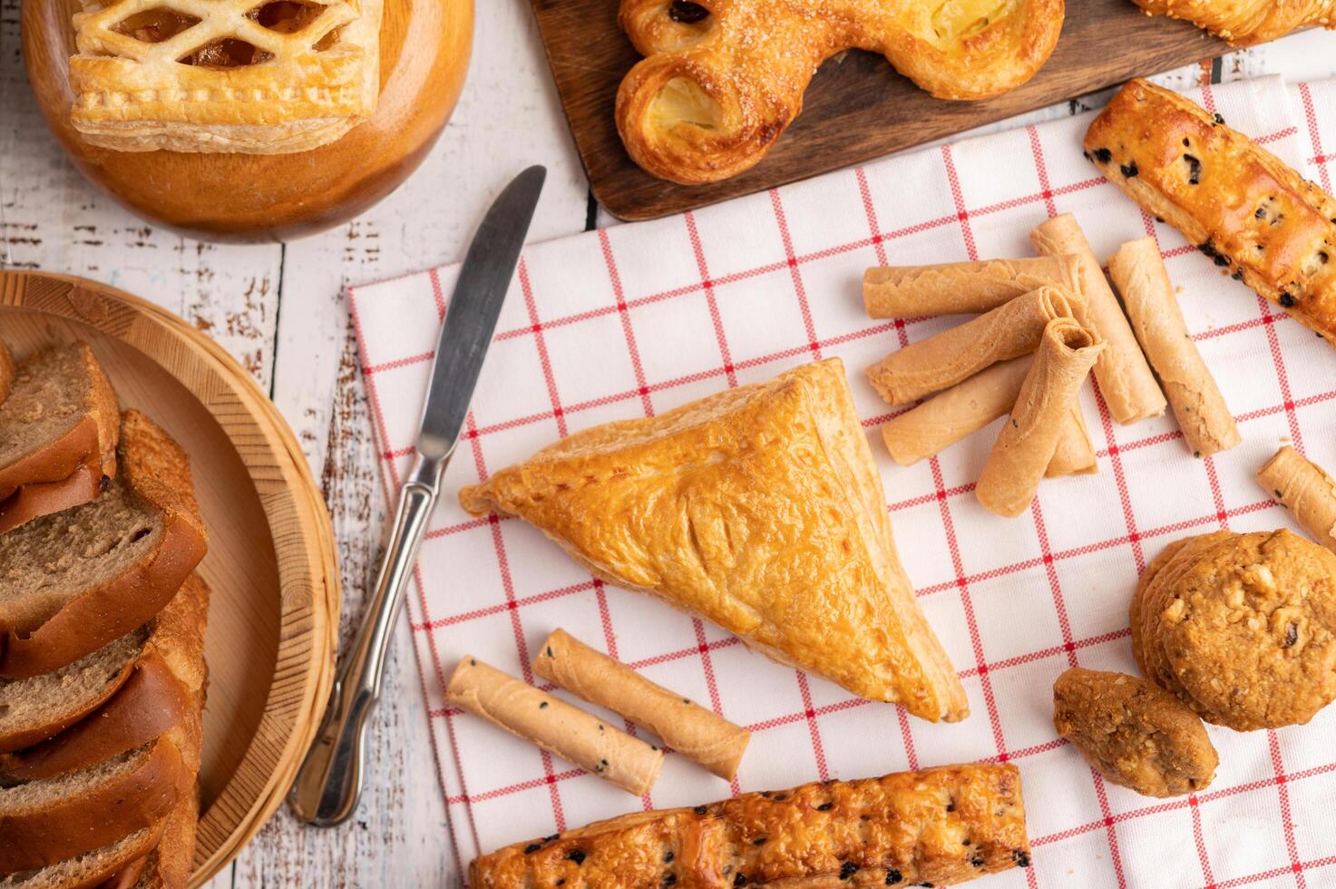 Various breads on red white cloth. Top view. photo