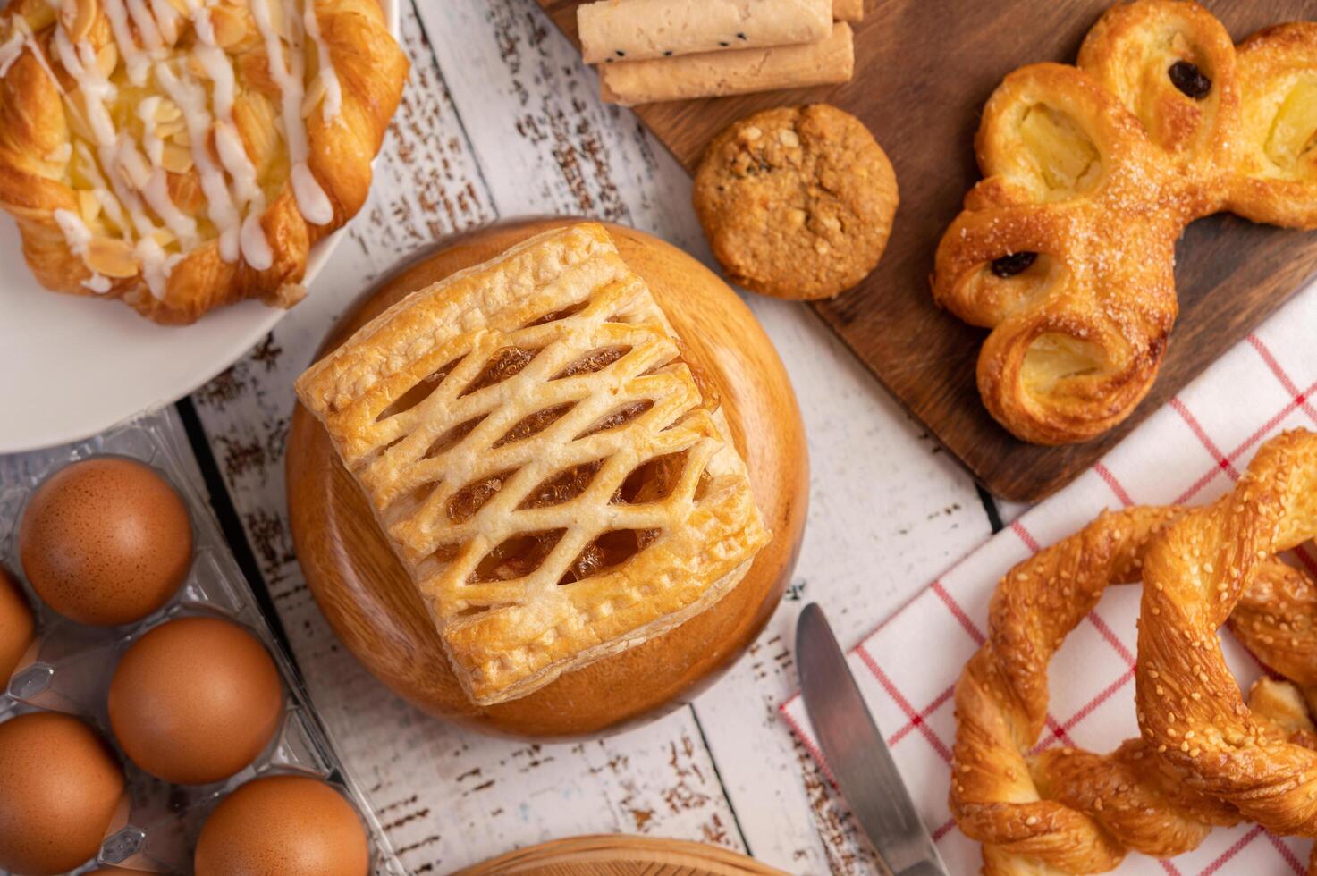 Various breads and eggs on red white cloth. Selective focus. photo