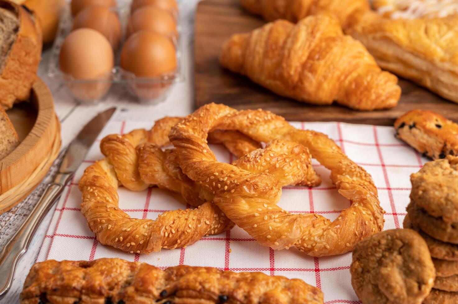 Various breads and eggs on red white cloth. Selective focus. photo