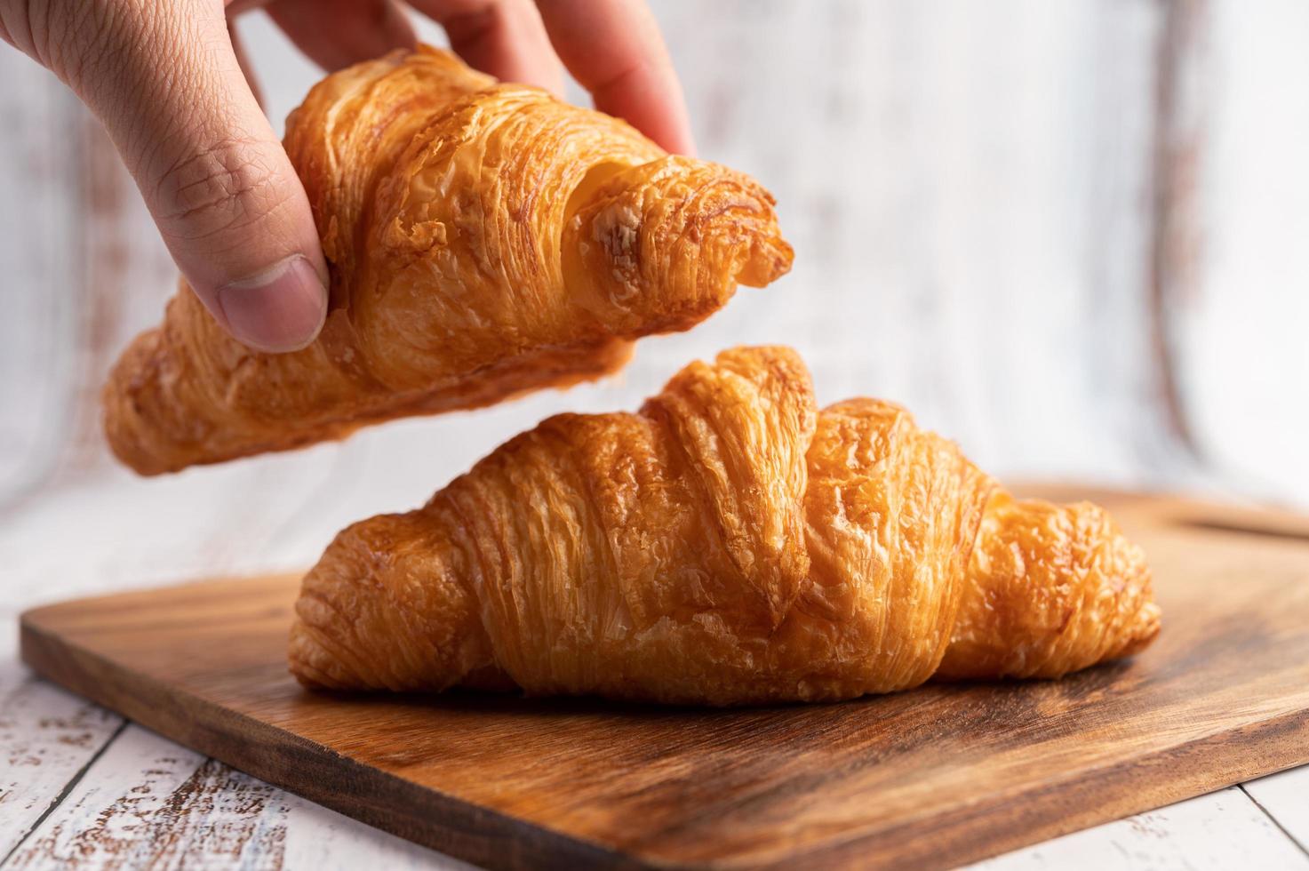 Croissants on a wooden cutting board. Selective focus. photo