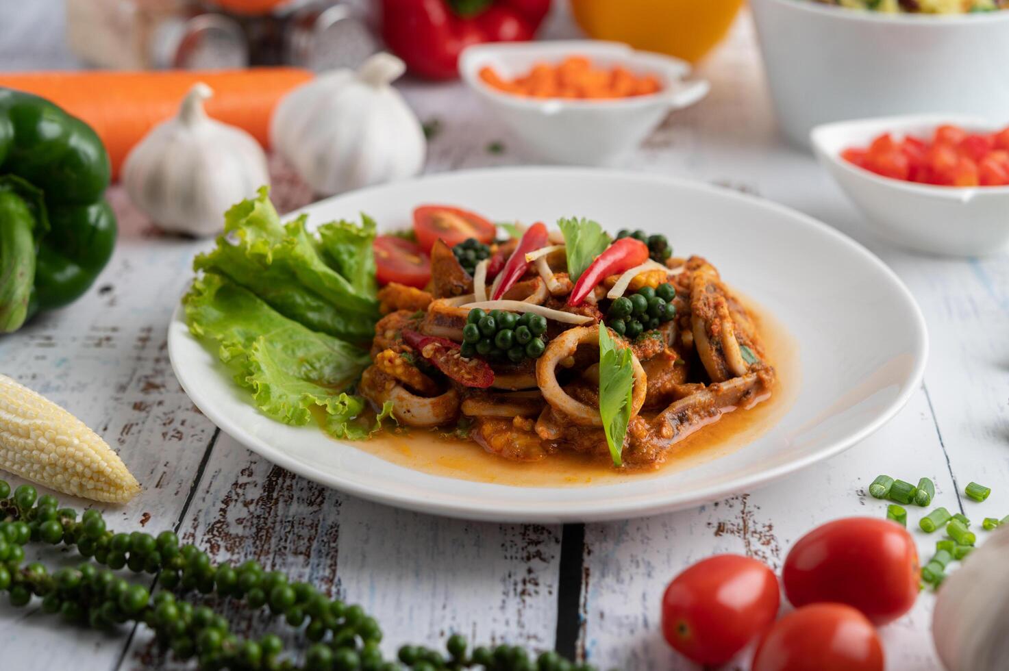 Stir-fried squid with curry paste in white plate. photo