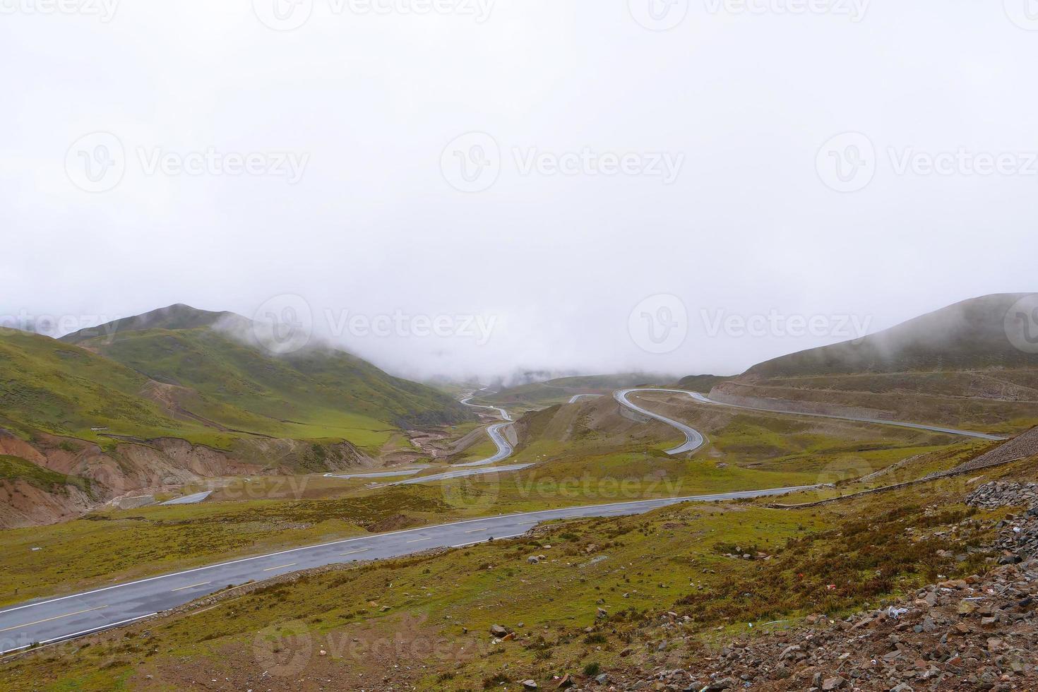 Road around the mountain cloudy day in Qinghai Province China photo