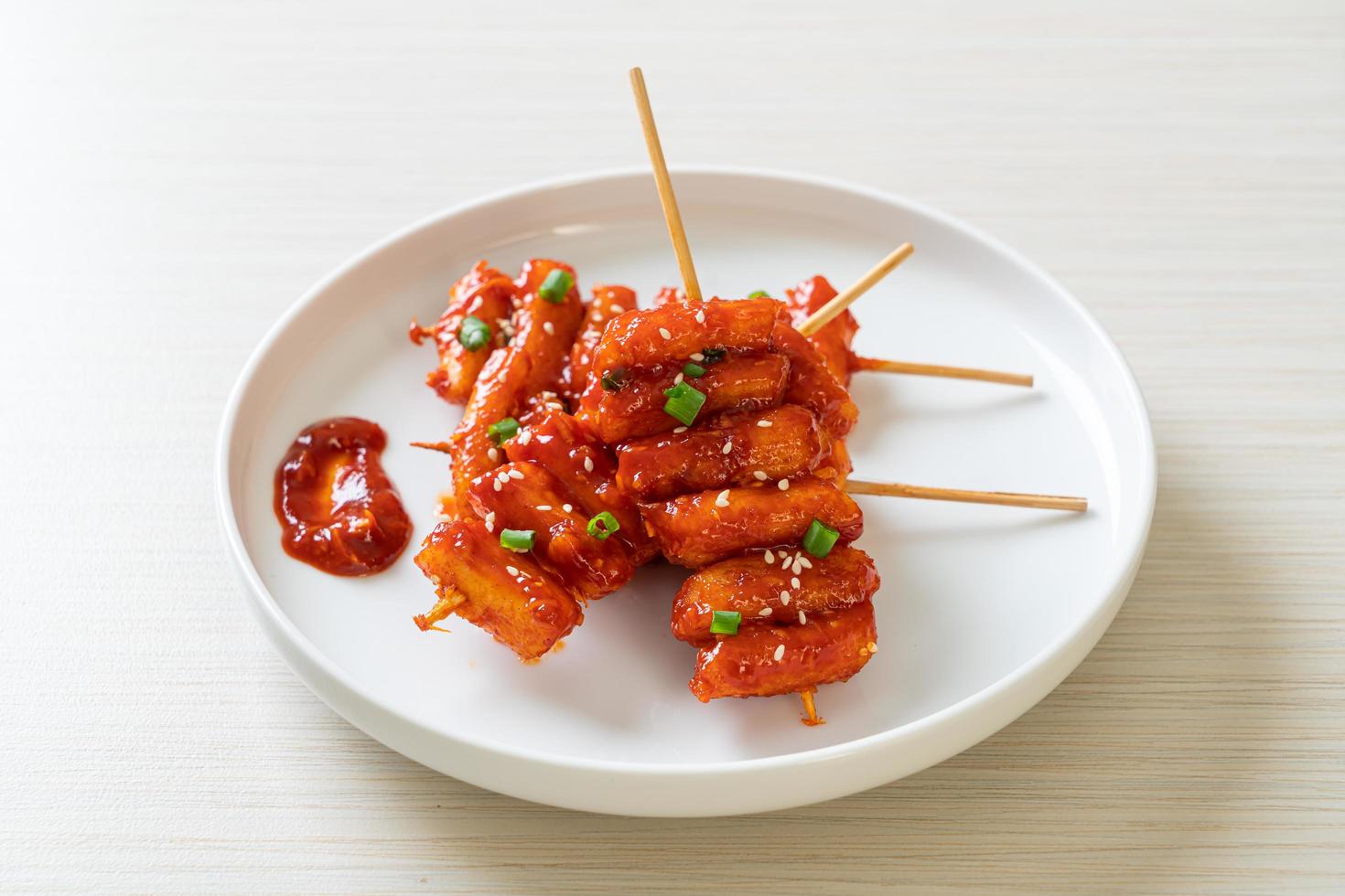 Deep fried Korean rice cake skewered with spicy sauce photo