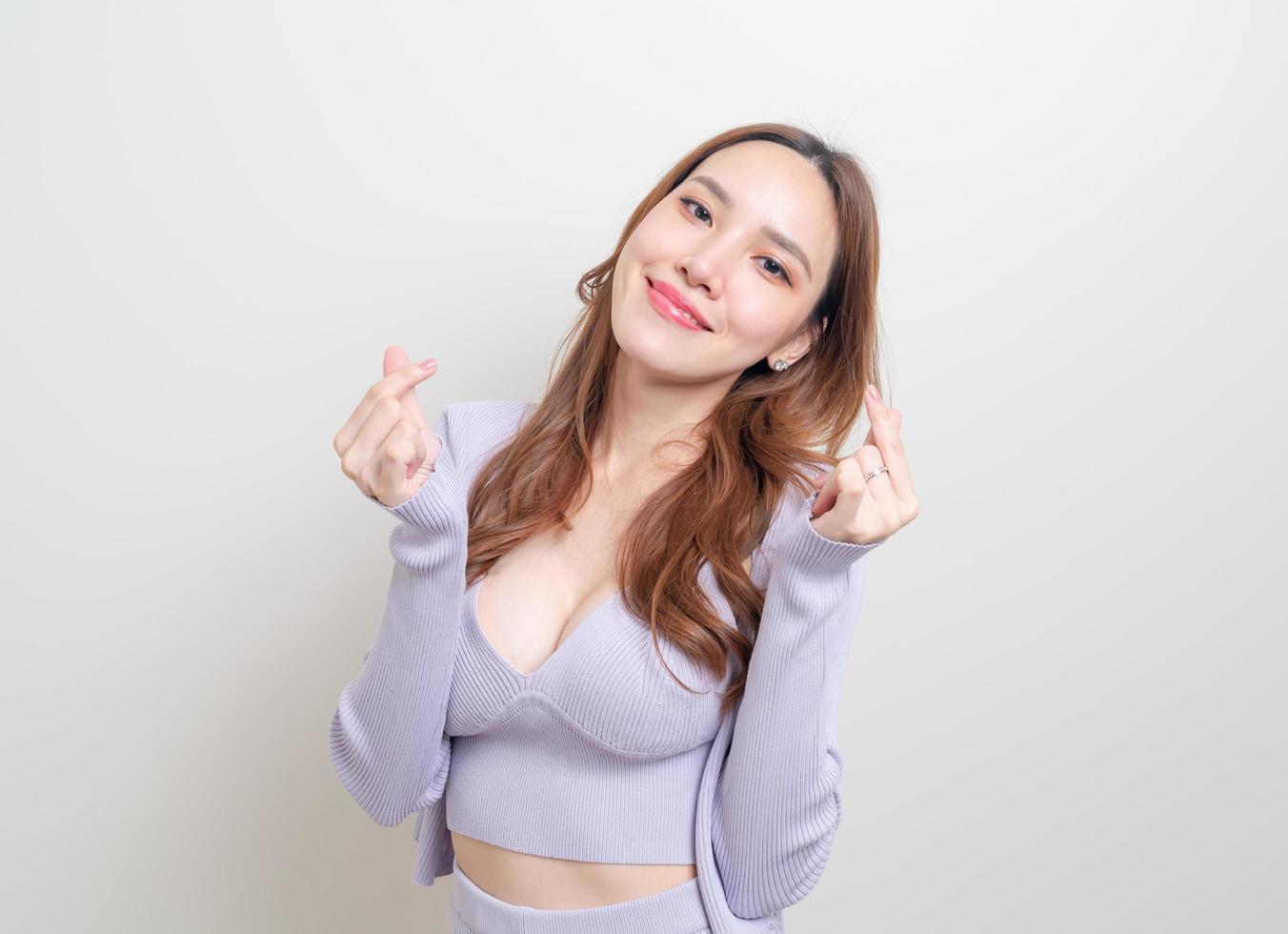 Portrait beautiful woman with mini heart hand sign photo