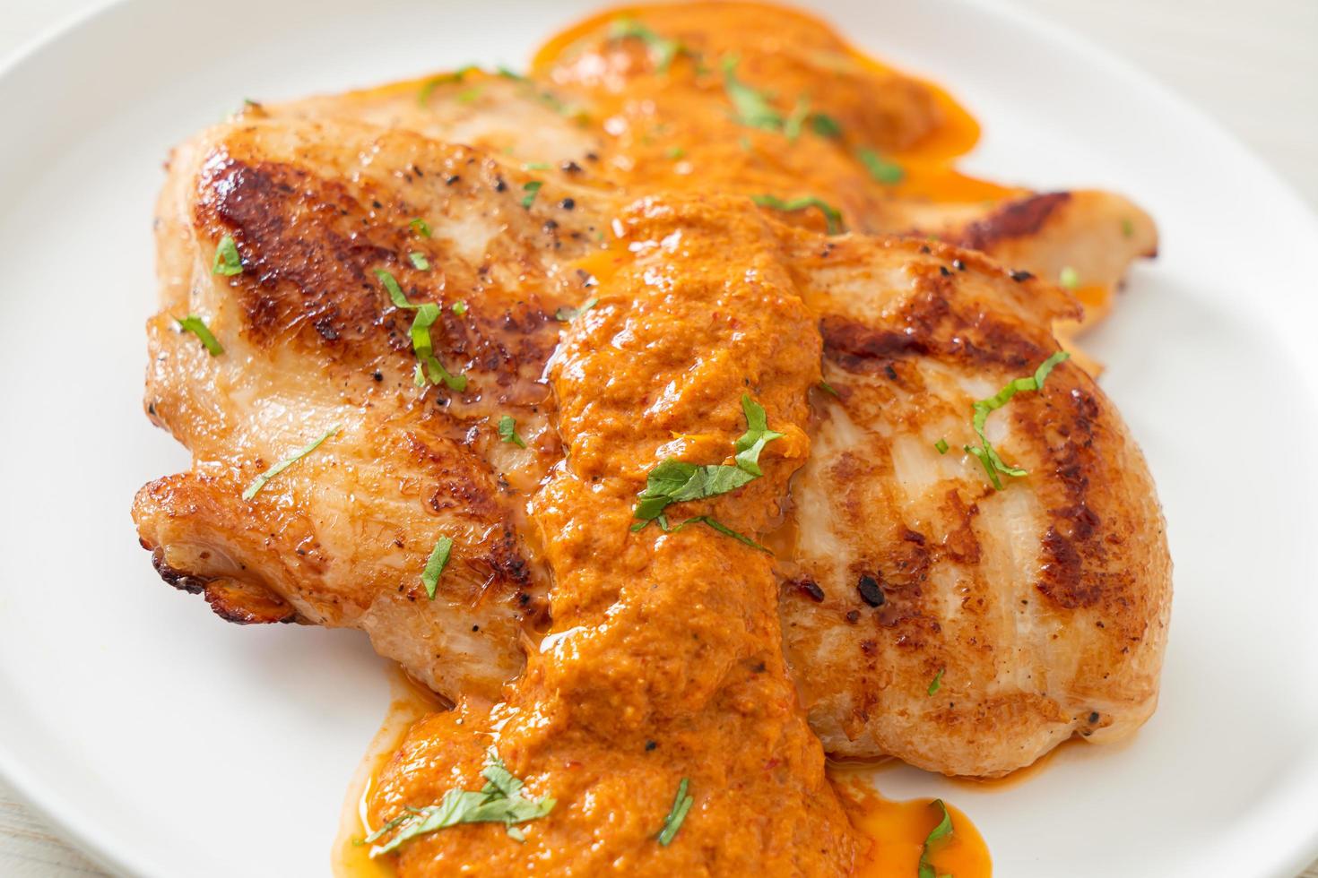 Grilled chicken steak with red curry sauce photo
