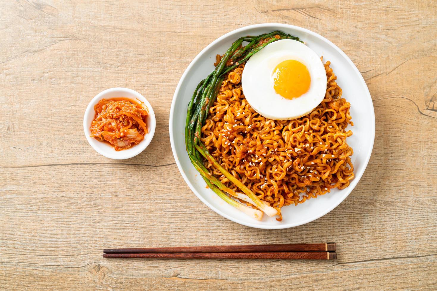 Dried Korean spicy instant noodles with fried egg photo