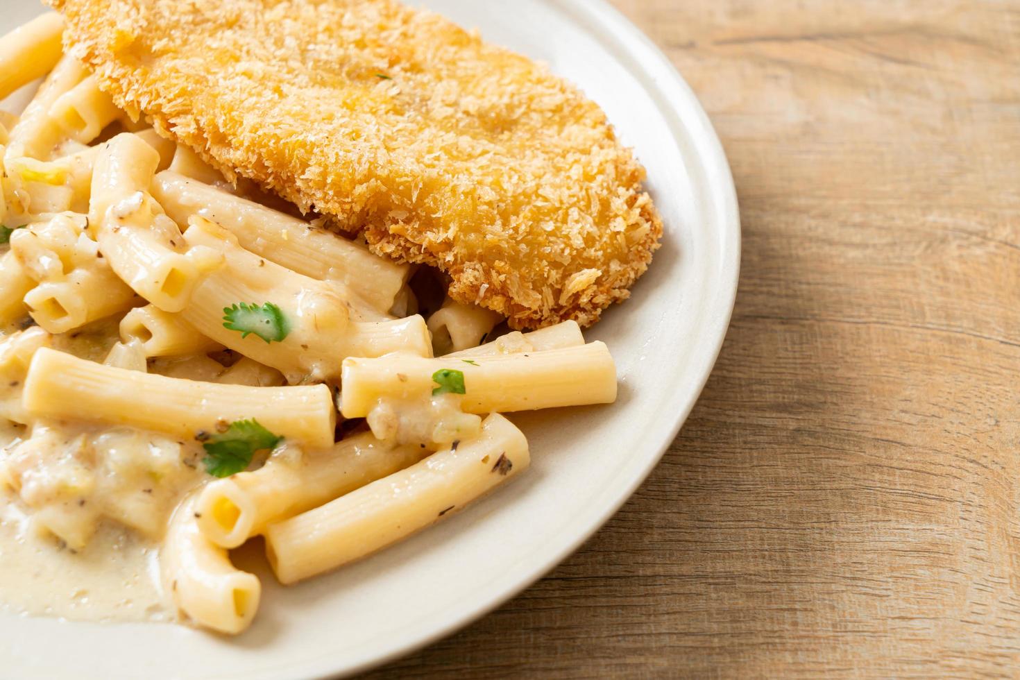 Quadrotto penne pasta white cream sauce with fried fish photo