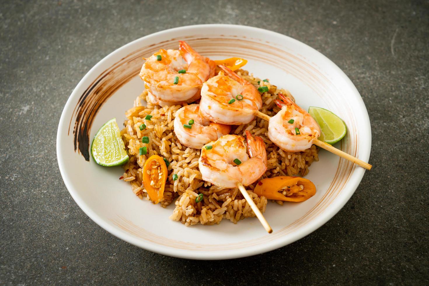 Fried rice with shrimps skewers photo