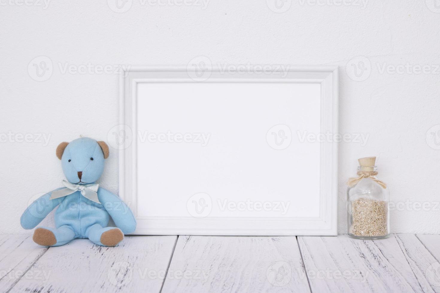 White frame with bottle and bear photo