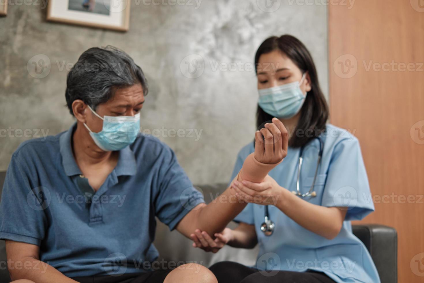 Female doctor physical therapy on senior male patients. photo