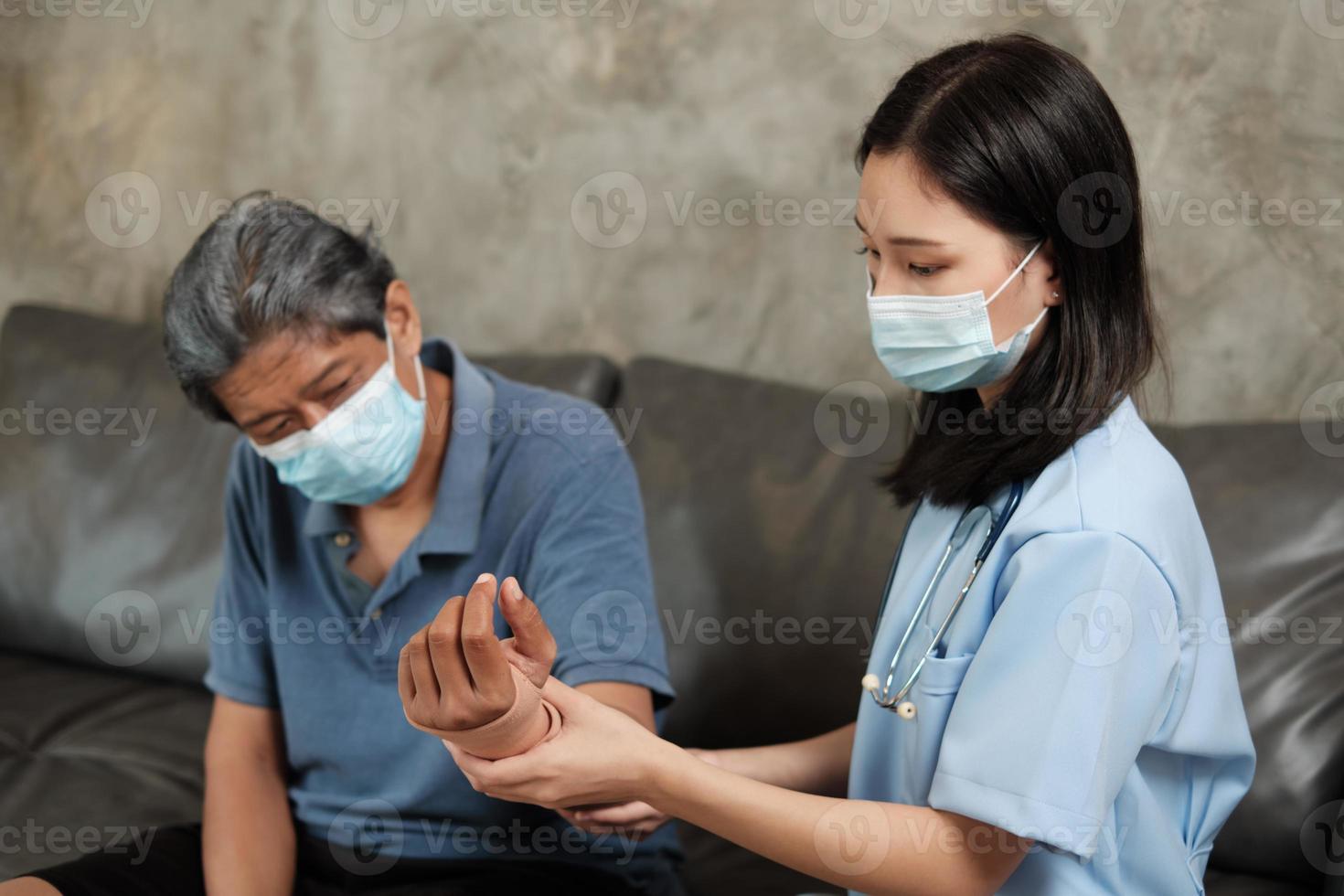 Female doctor physical therapy on senior male patients. photo