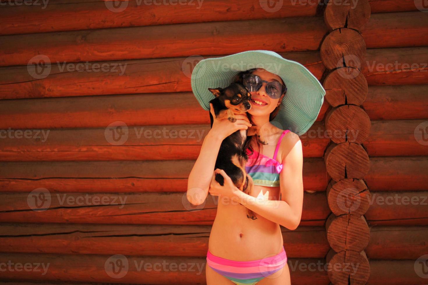 girl holding pet dog chihuahua outdoors. Summer. Togetherness. photo