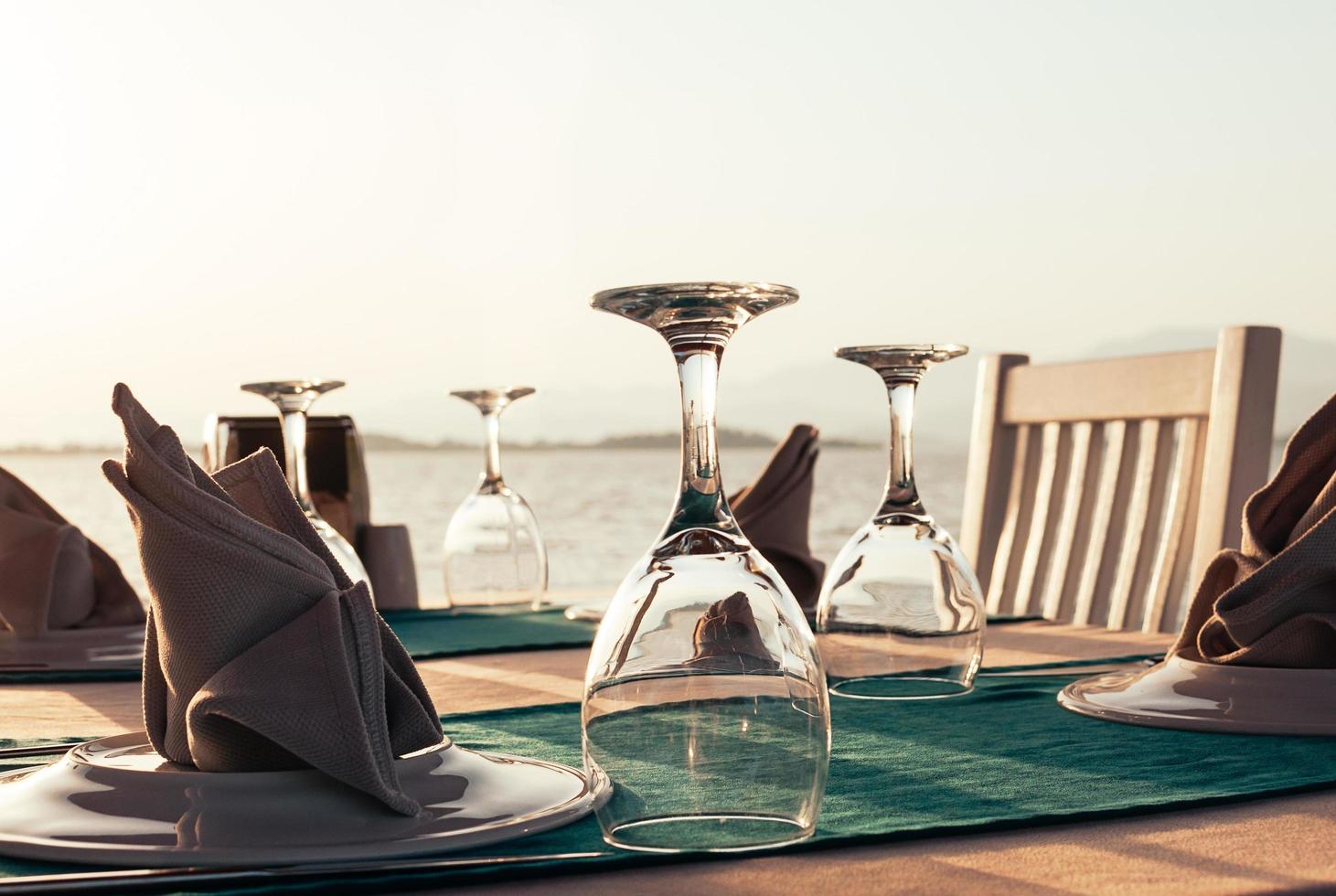 table setting at beach restaurant at sunset photo