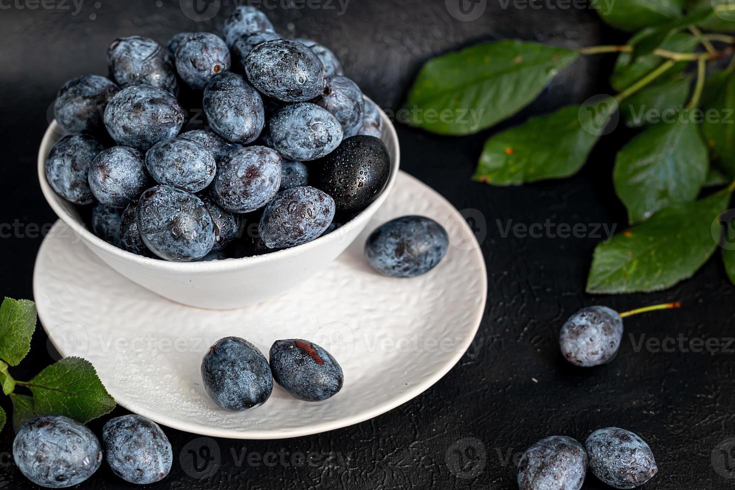 Plums on a dark background. Harvesting the autumn harvest photo