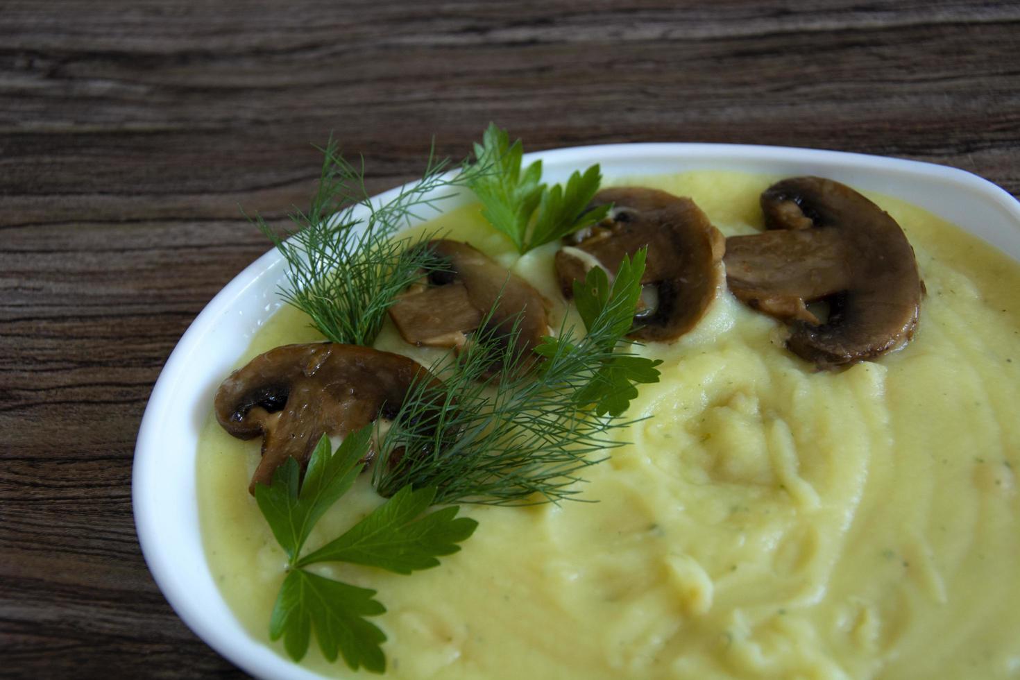 A garnish of champignon mushrooms with mashed potatoes photo