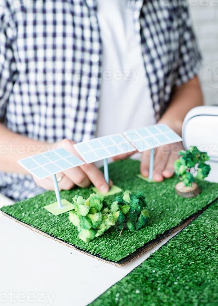 Young man making renewable energy project dummy photo