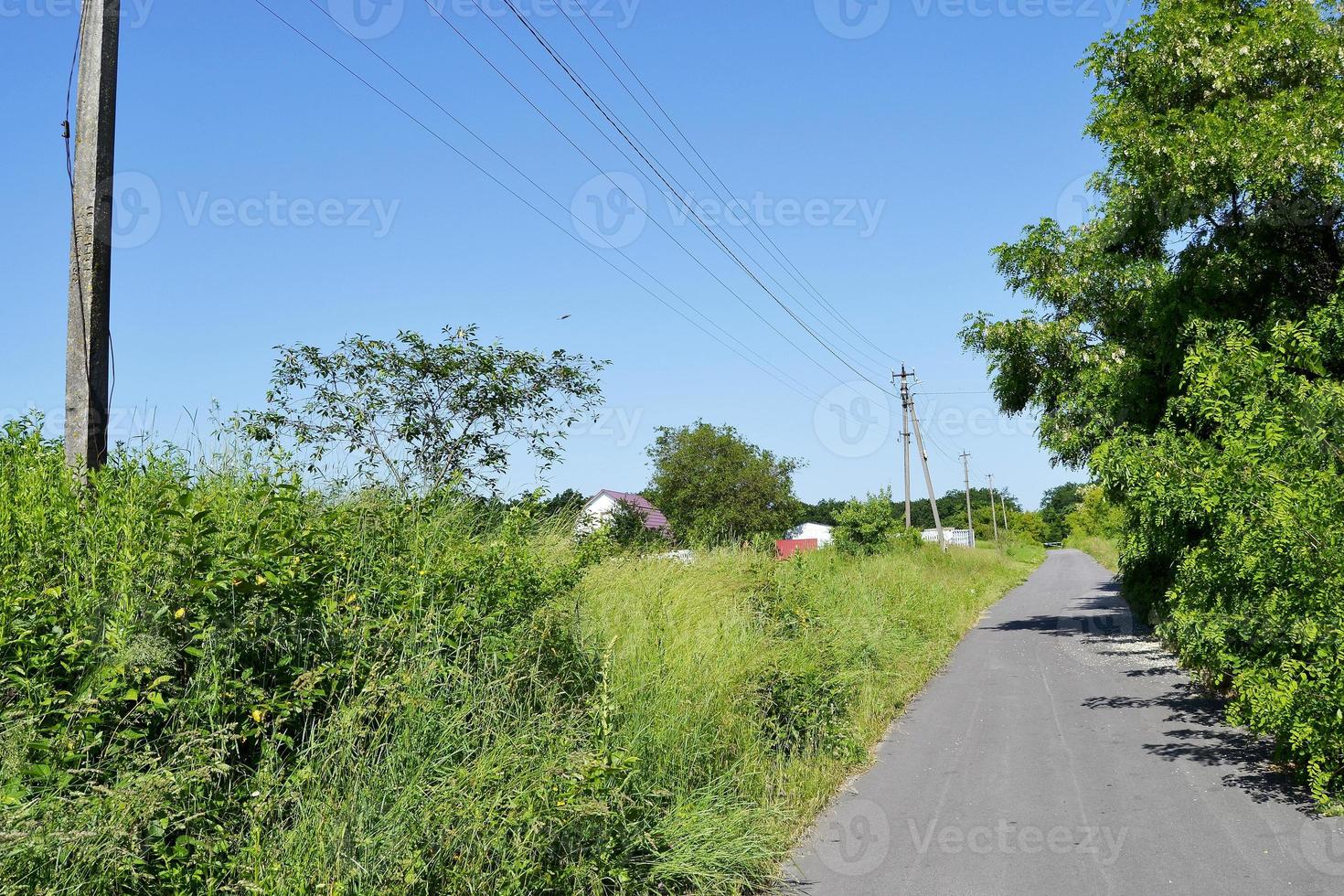 Beautiful empty asphalt road in countryside on colored background photo