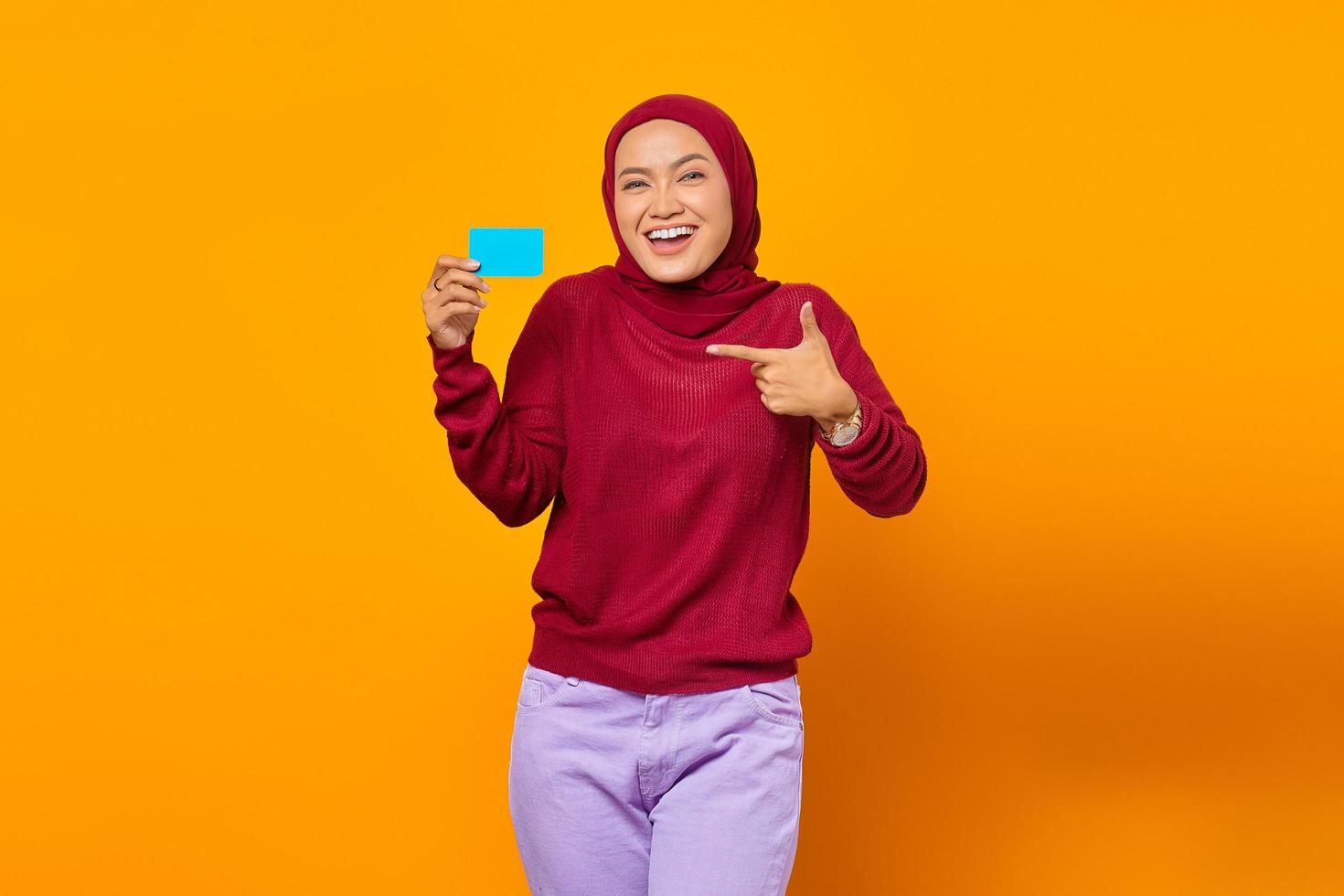 Smiling Asian woman show gesturing finger blank card photo