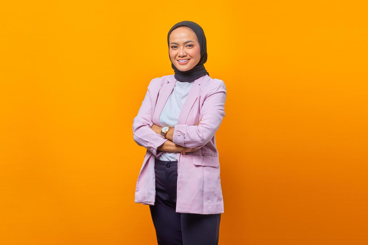 Smiling Asian business woman crossing her arms in business suit photo