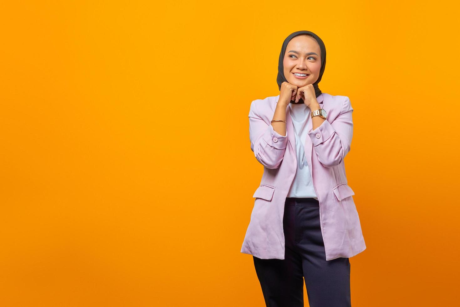 Businesswoman looking cheerfully aside with folding raised arms photo