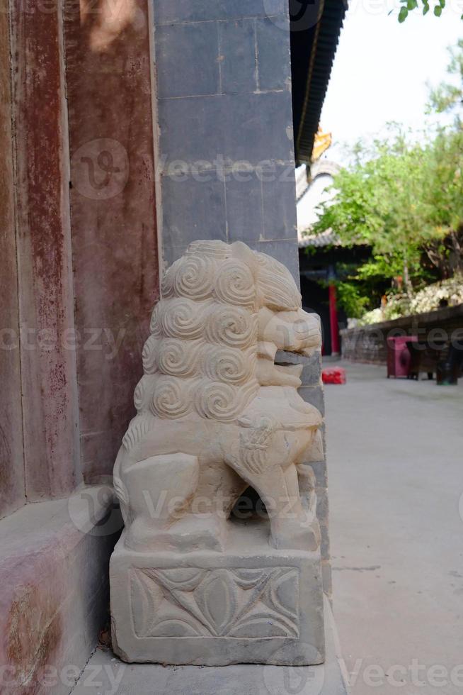 Stone lion statue in Tulou Temple of Beishan Mountain in Xining China. photo
