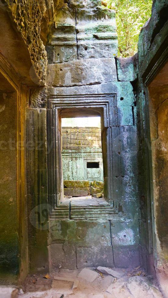 Stone ruin window at Ta Prohm Temple , Siem Reap Cambodia. photo