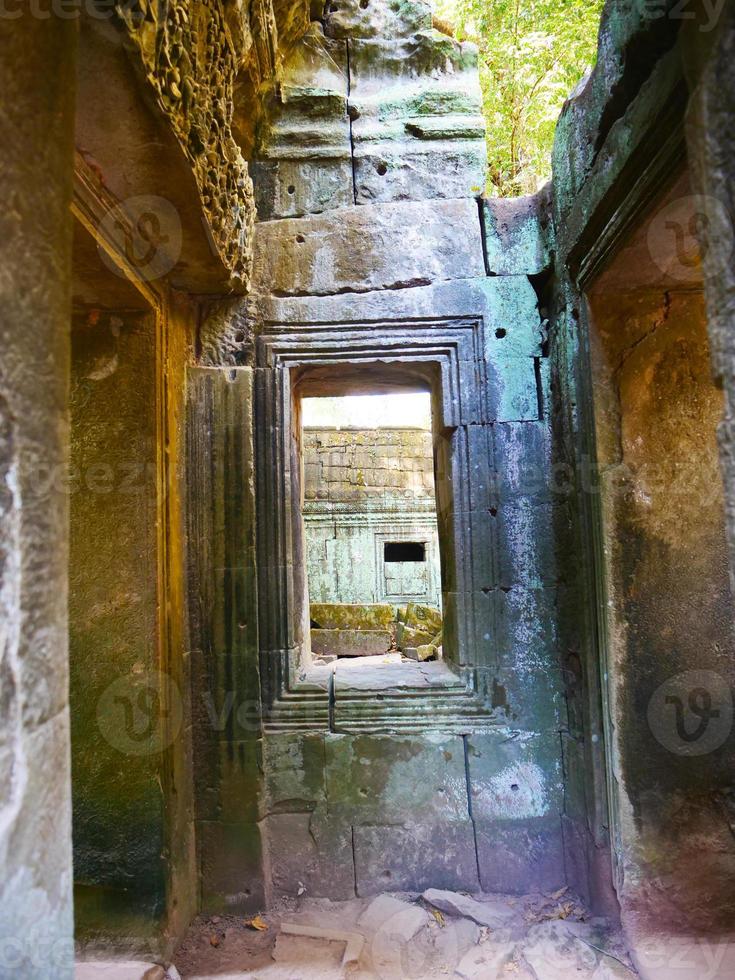 Stone ruin window at Ta Prohm Temple , Siem Reap Cambodia. photo