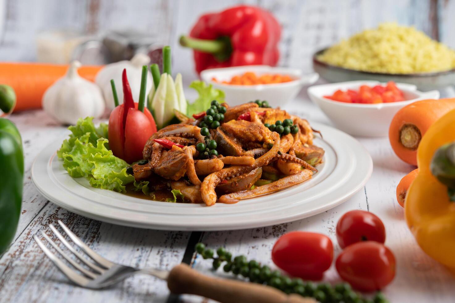 Stir-fried squid with curry paste in white plate. photo