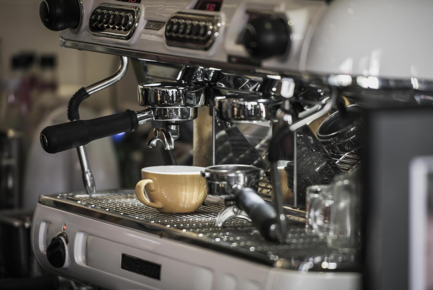 Coffee machine with coffee cup at cafe photo