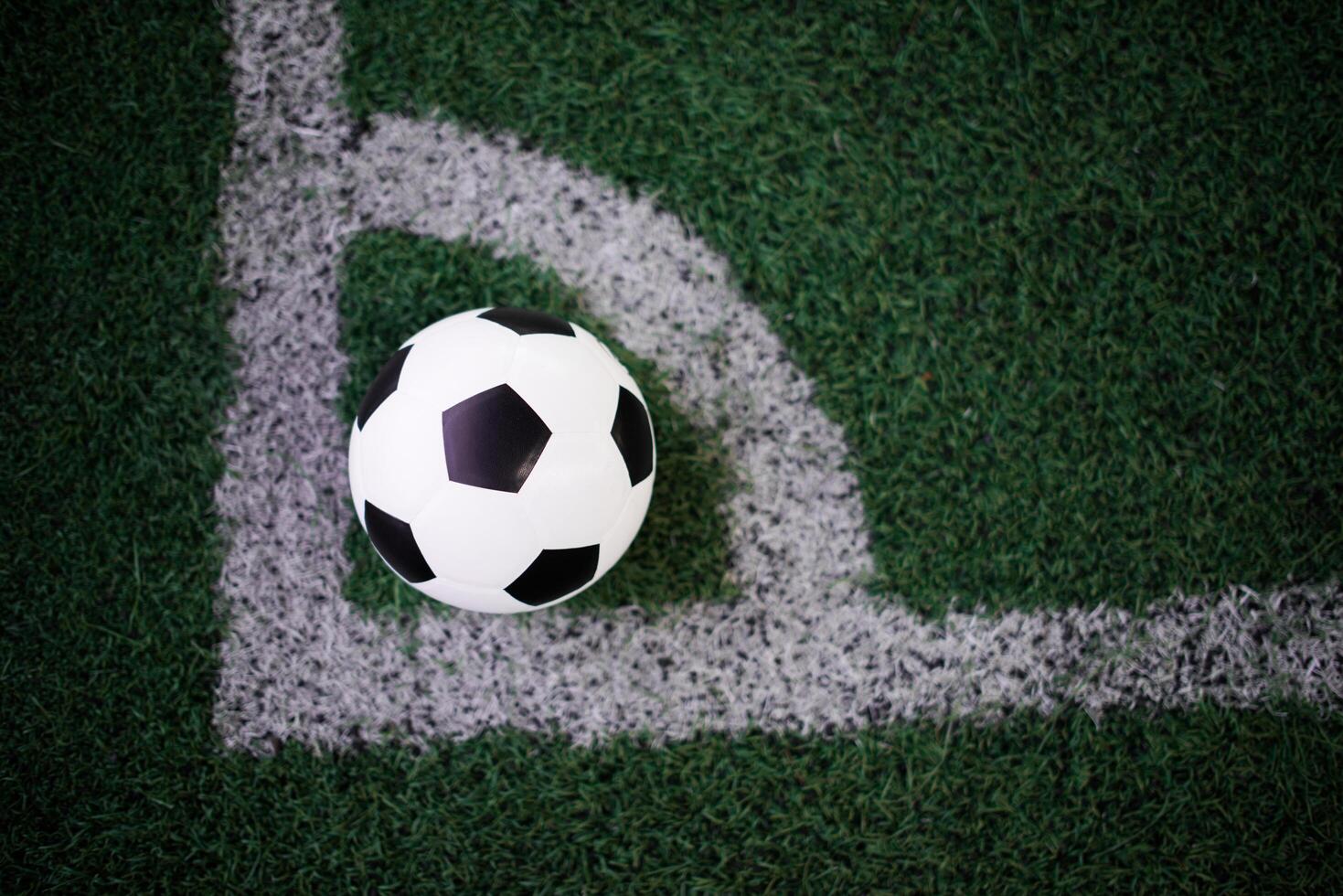 soccer ball on the white line at stadium photo