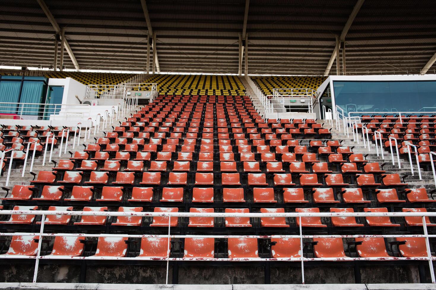 Red Empty and old plastic seats in the stadium. photo