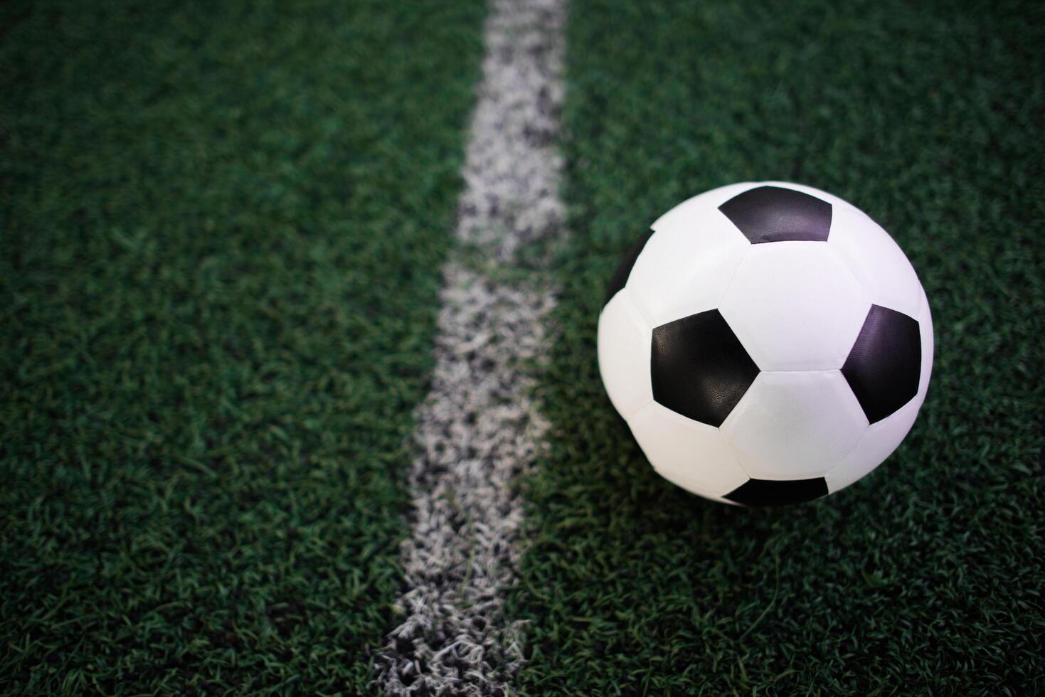 soccer ball on the white line at stadium photo