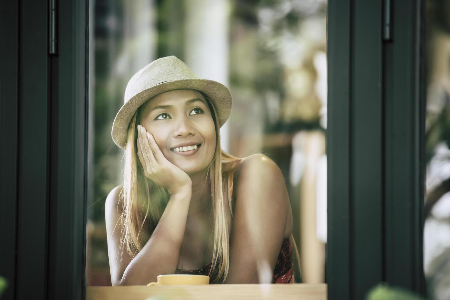 Happy young woman with latte coffee in morning photo