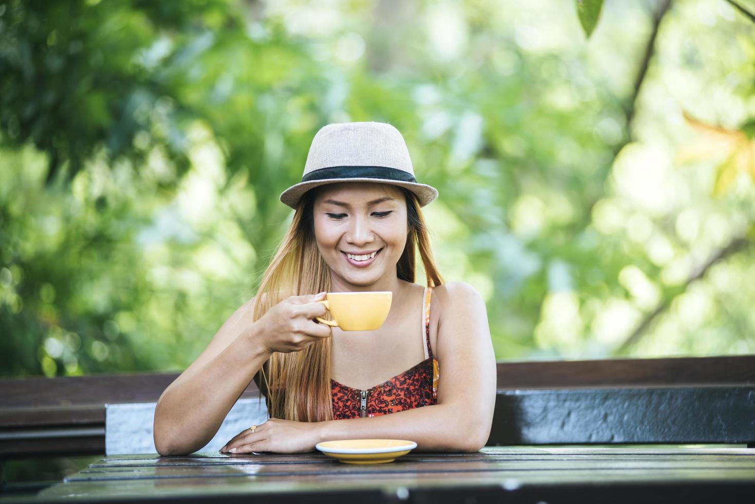 Happy young woman with latte coffee in morning photo