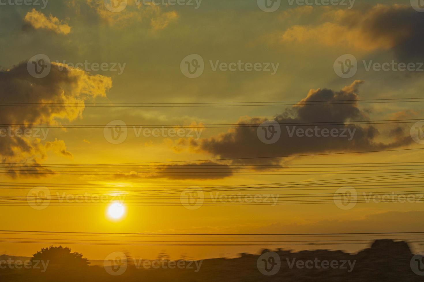 Golden and colorful sunset with orange yellow blue green colors. photo