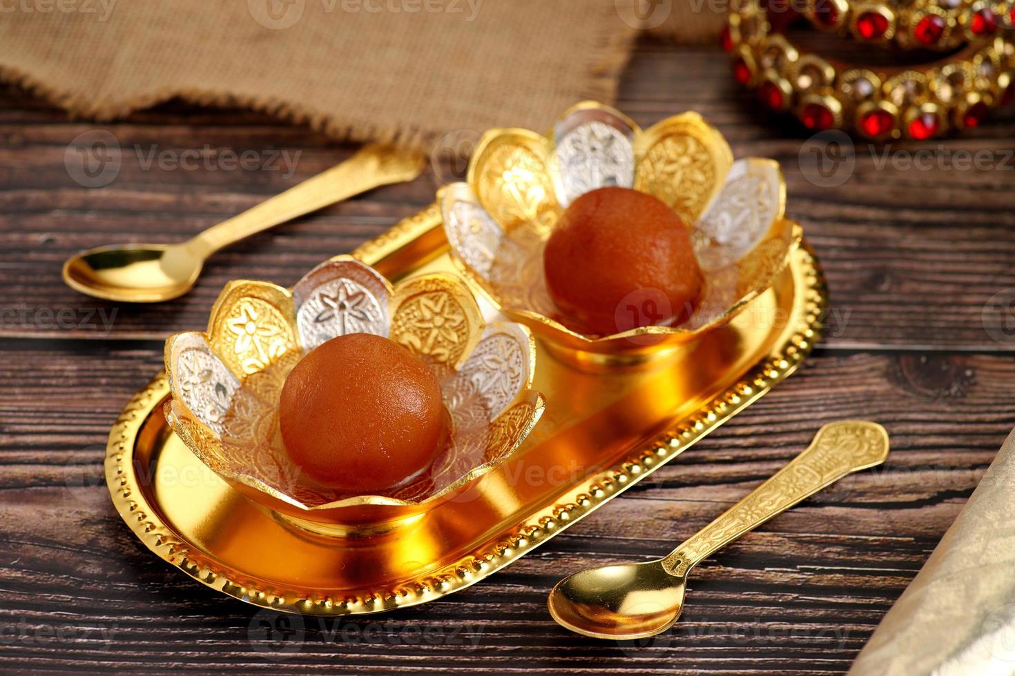 Indian Dessert Sweet Food Gulab Jamun in a traditional metal bow photo