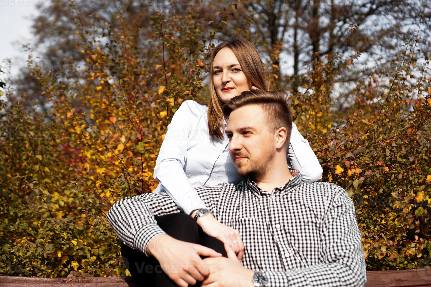 Romantic couple in autumn park - love, relationship and dating concept photo