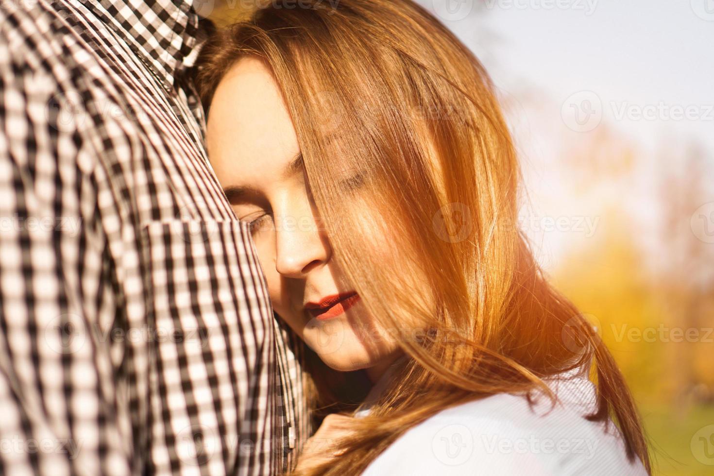 Romantic couple in autumn park - love, relationship and dating concept photo