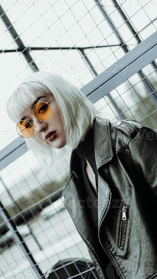 Portrait of woman with white hair and glasses. Modern urban style photo