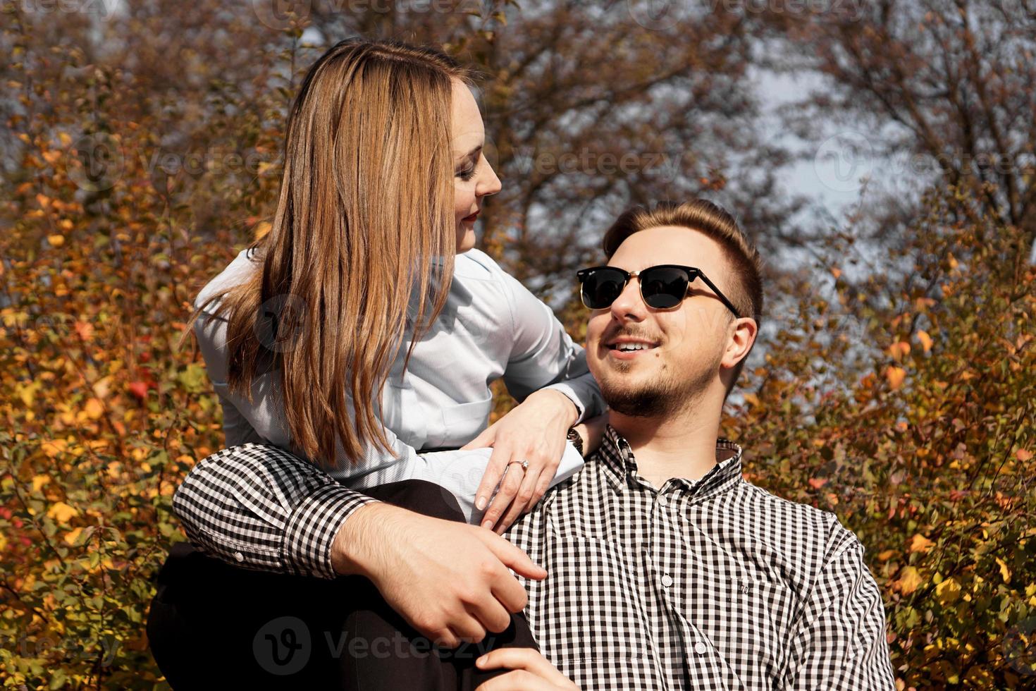 Romantic couple in autumn park - love, relationship and dating concept photo