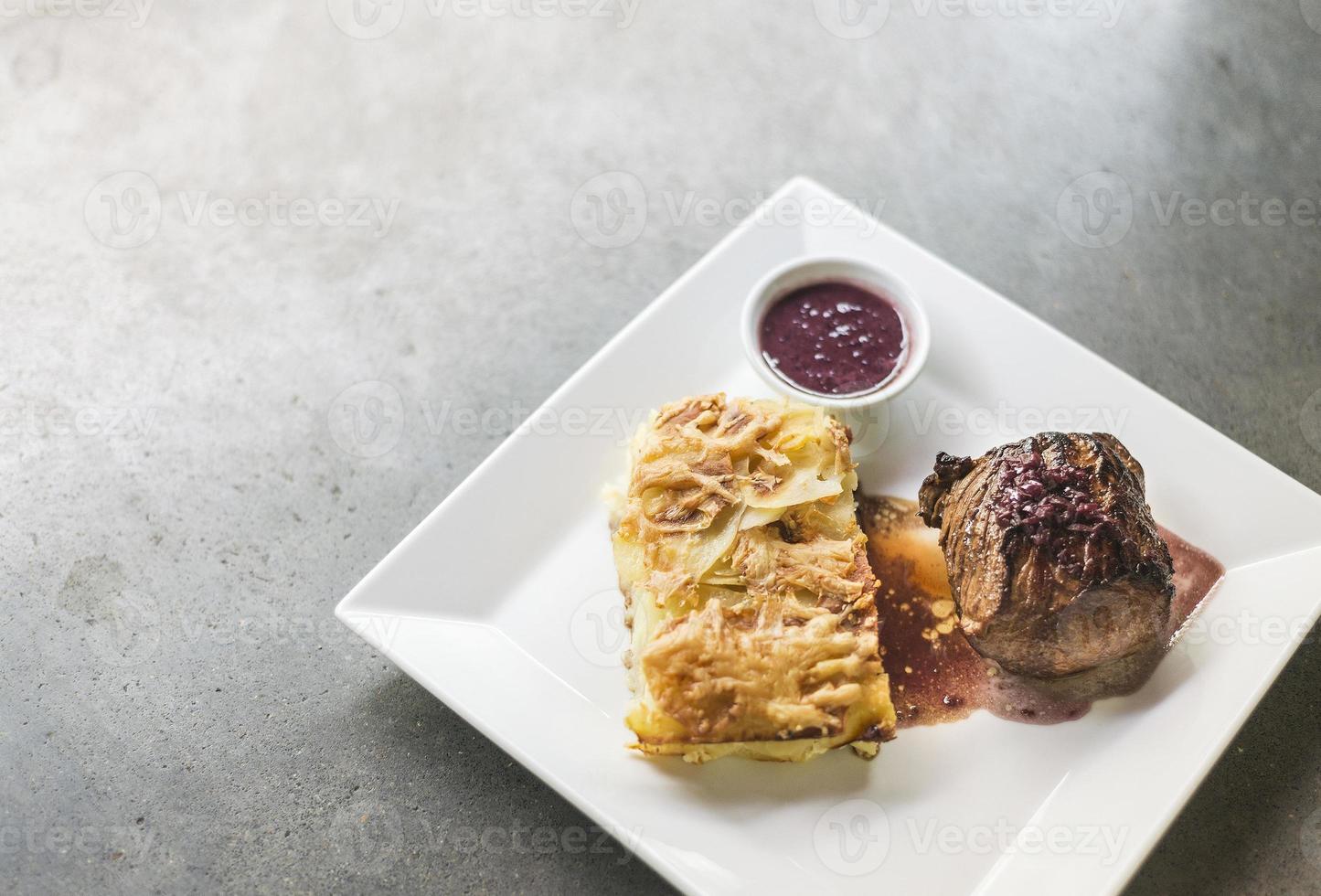 roast beef with potato cheese bake and beetroot sauce photo