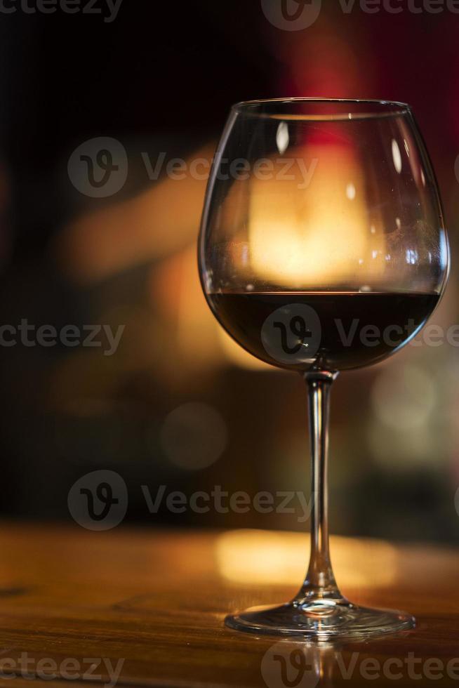 glass of red wine in cozy bar interior photo