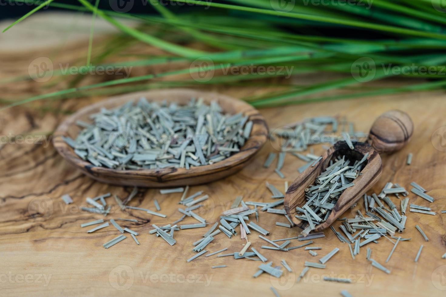 Dried lemongrass on olive wood photo