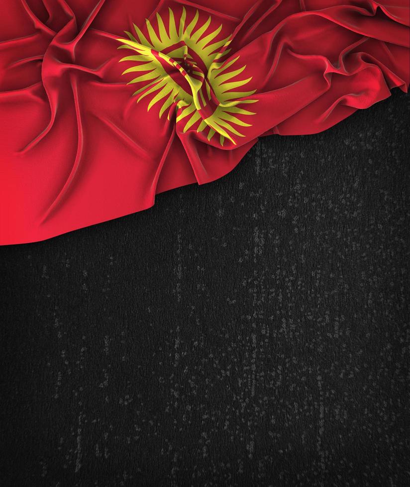 Kirguistán bandera vintage en una pizarra negra grunge foto